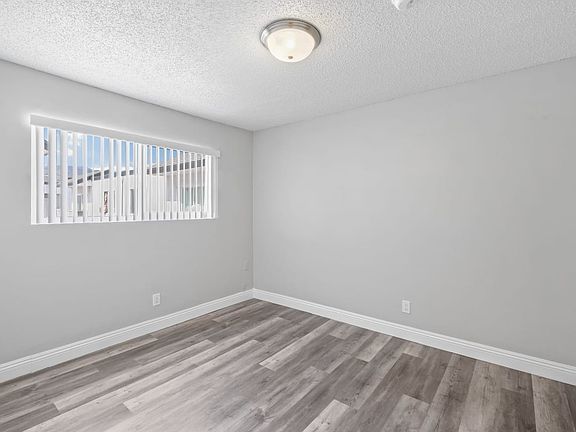 Sage I a spacious bedroom with hardwood floors and a large window Interior bedroom view