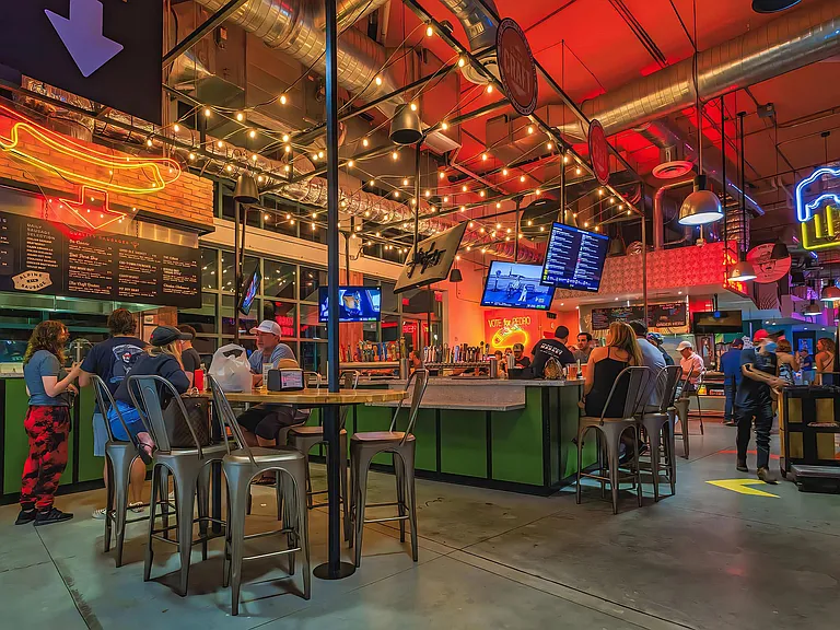 Bustling Bar Scene with String Lights and Social Vibe Close to South of Atlantic