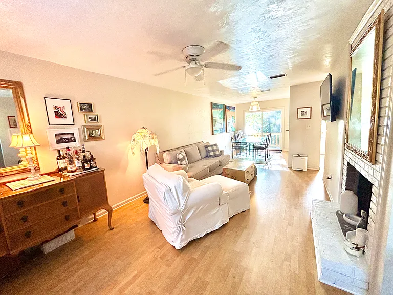 Living And Dining Areas Featuring a View of The Back Deck