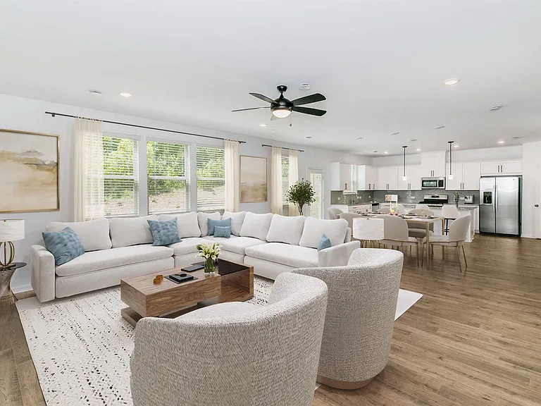 Living room with open view to kitchen and hallway.