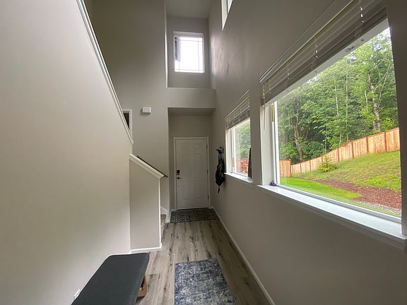 Entry way with views of the forest and natural lighting.