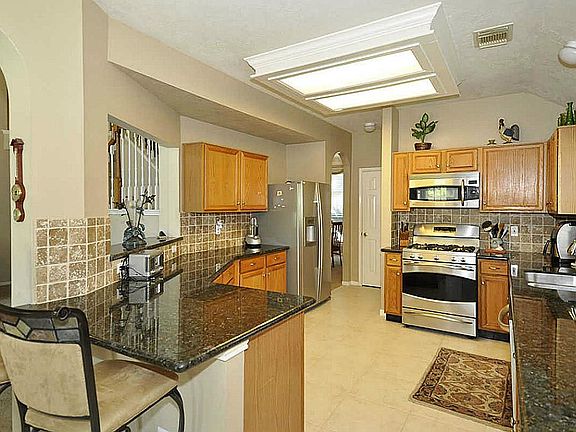 Gourmet chefs will enjoy the generously sized kitchen complete with unlimited counter & cabinet space. Custom tile back splash.