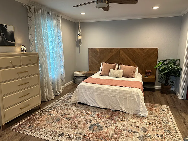 Primary bedroom is spacious with its own patio and electric fireplace installed on the wall.