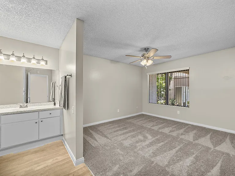 Bedroom and bathroom at Bay Breeze Apartments in Costa Mesa, CA