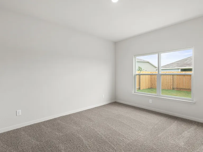 The master bedroom has a large window that lets in great, natural light and backyard views.