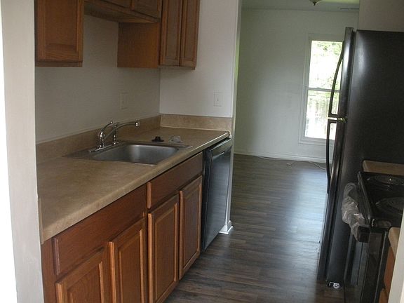 Kitchen leading to living room located at the back of the home.