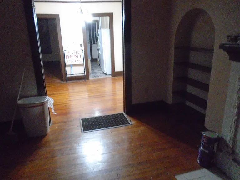 South looking view from the living room into the dining room of 124 NW 31st Street. the left door is to the bedroom and the right door is to the kitchen.