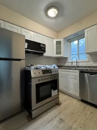 Kitchen - Brand new cabinets, new flooring, NEW stainless steel range, NEW microwave.