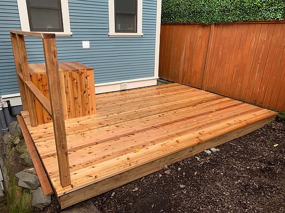 Large outdoor fenced yard with a big deck.