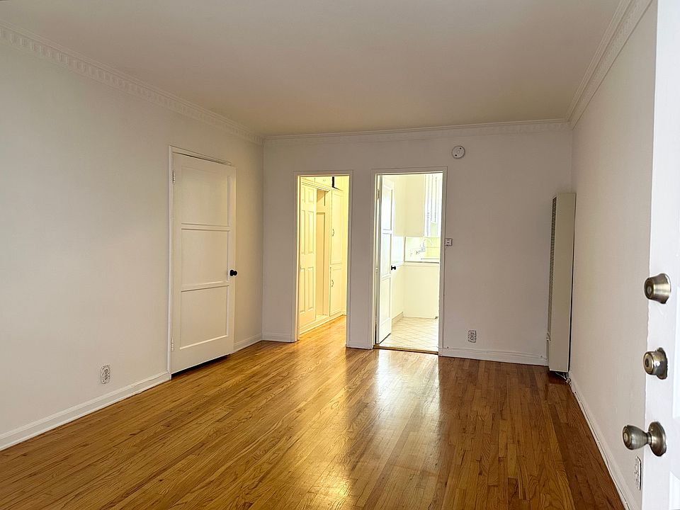 Living area showing large closets and door to kitchen and dining area