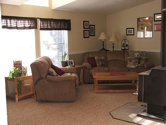 Living room features a woodstove and two-toned paint