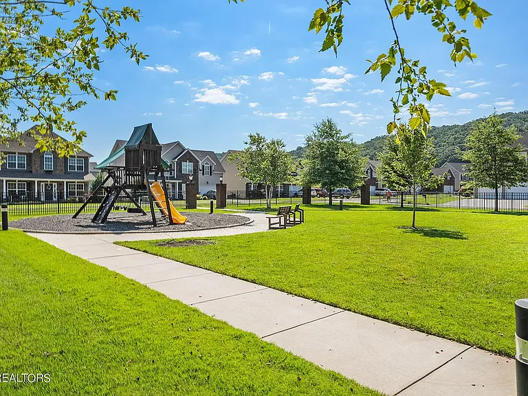 A premier neighborhood gathering space complete with high-end play ground equipment, inclusive swing sets, accessible sidewalk, and relaxing park benches
