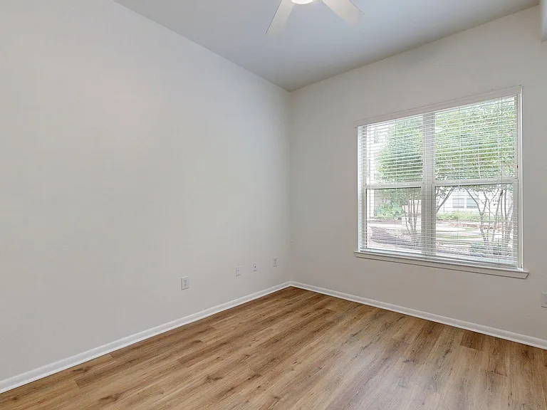 Spacious apartment Bedroom with wood style floor.