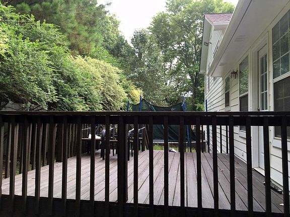 Spacious rear deck overlooks fenced back yard.
