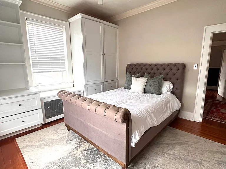 Guest room with queen bed, built-ins for storage