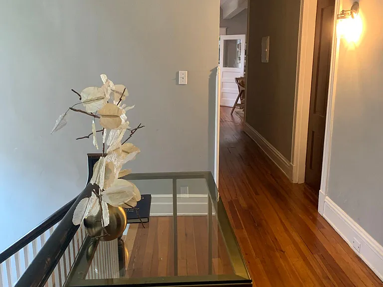 Second level landing opens up to hallway access for primary suite, two additional bedrooms, additional full bathroom, kitchen and common living area