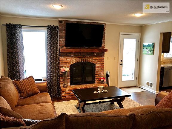 Living Room with entrance to backyard! Cozy fireplace, Newer HVAC!