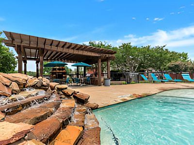 Resort-style community pool with sun deck and lounge seating.