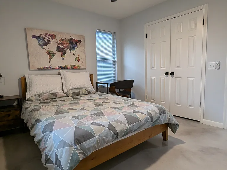 Another view of the guest bedroom and the double-door closet space