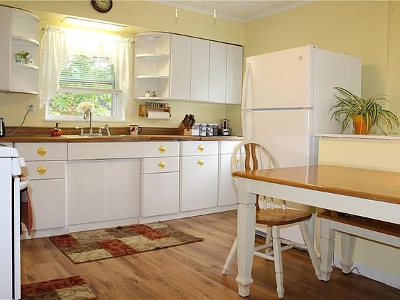 Beautiful and bright kitchen with newer appliances and laminate wood flooring.