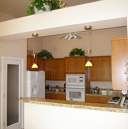 Lovely kitchen with granite counters, ample cabinet space & pantry