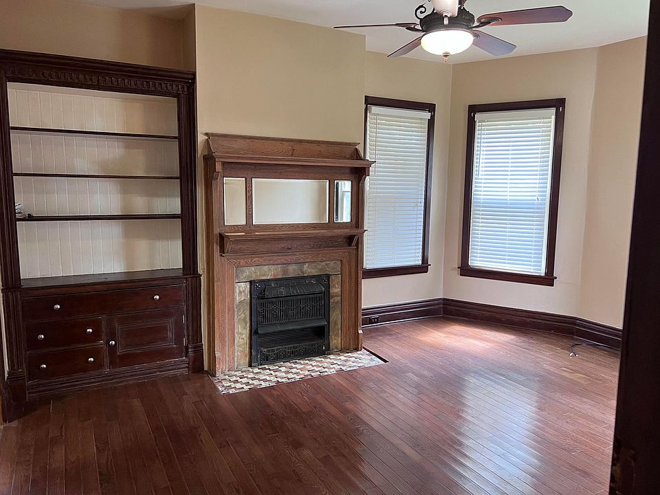 Living room with buit-ins, fireplace with mantle. Great hardwood floors.