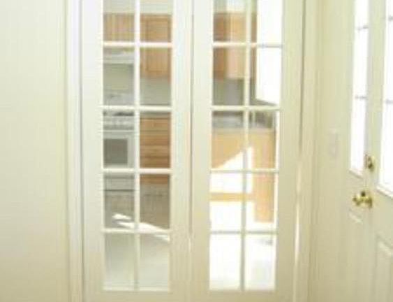 There are french doors from the front Entry into the Kitchen area.