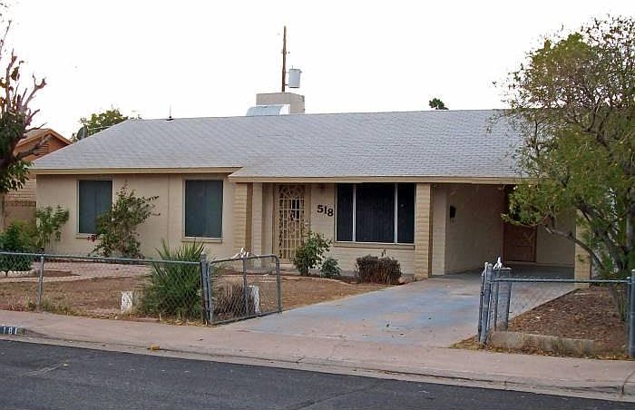 Front exterior, long driveway with carport