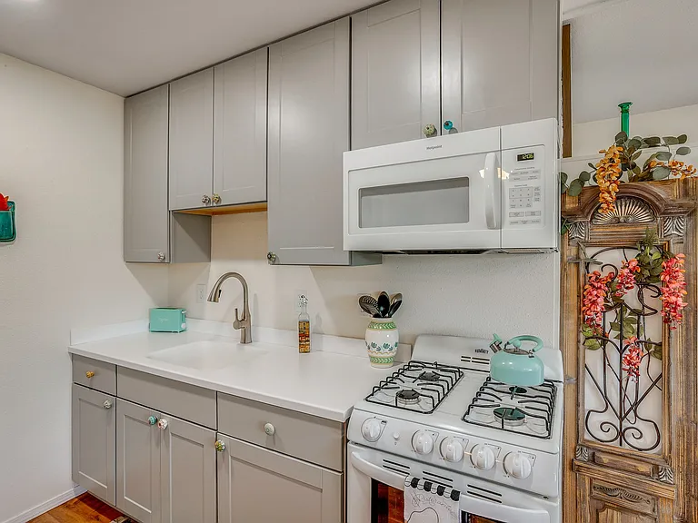 Gas stove, oven, microwave, sink, counter, cabinets,