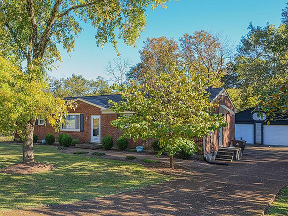 north & west faces 335 Dade Drive viewed from street with garage