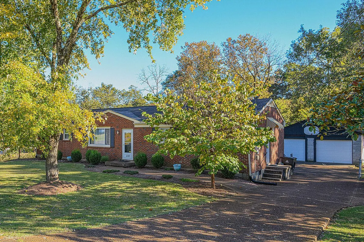 north & west faces 335 Dade Drive viewed from street with garage - 335 Dade Dr