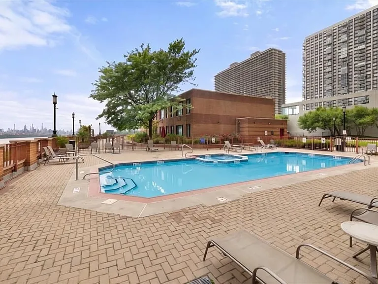 Pool with sunchairs and umbrellas