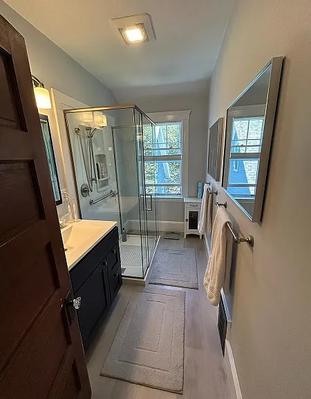A newly renovated bathroom on the 3rd floor with natural light, privacy, and views make it seem like one is always able to shower in a natural setting.