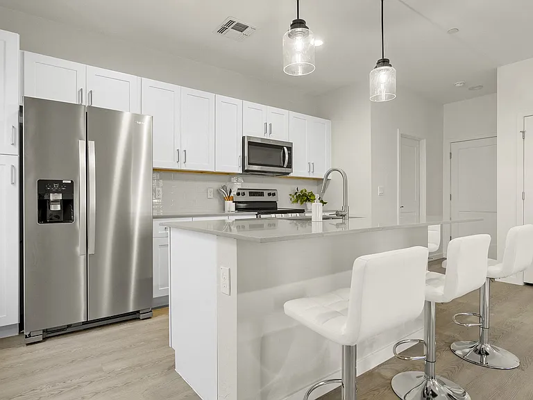 Large kitchen area with stainless steel appliances