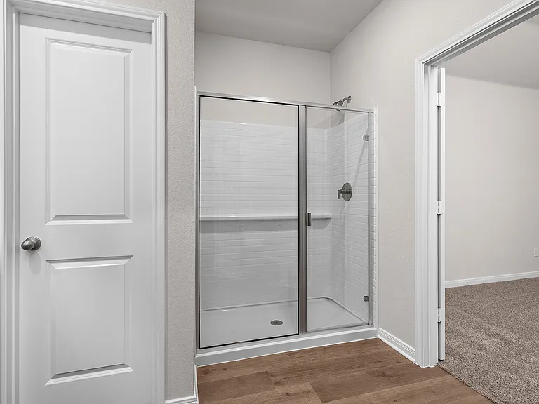 The master bathroom has a glass, walk-in shower.