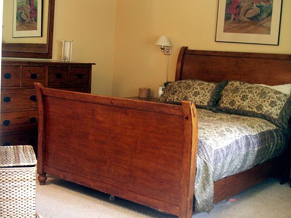 The master bedroom has vaulted ceiling and a wonderful view of the garden