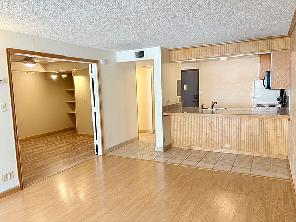 View from living area, second bedroom/den left, kitchen right