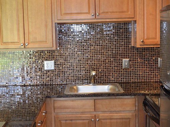 There is no popcorn in this kitchen.  All popcorn ceilings removed.