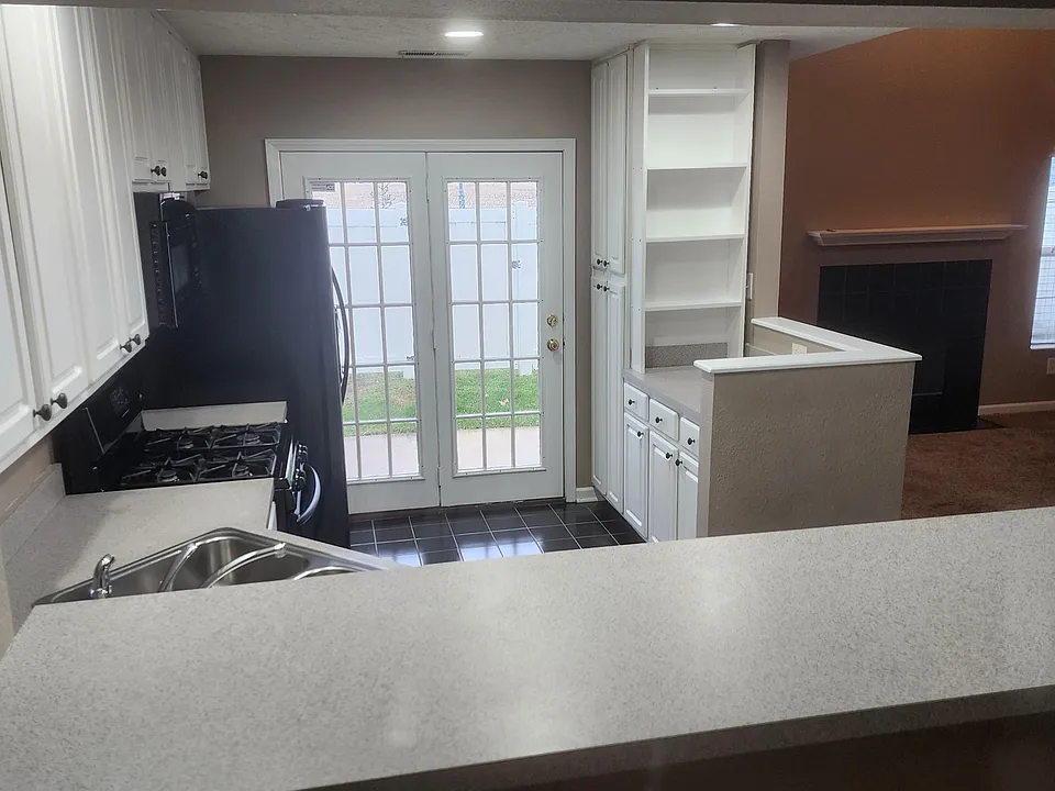 Sitting at breakfast bar looking into kitchen & family room to the right