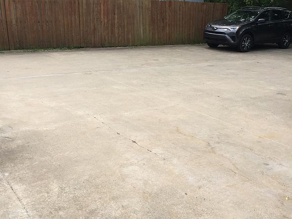 Large paved parking lot exclusively for tenants use directly behind building.