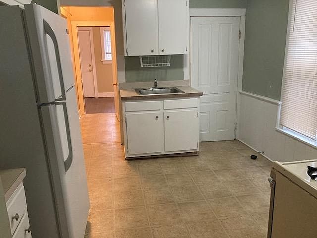 Kitchen into hallway to three season sunroom
