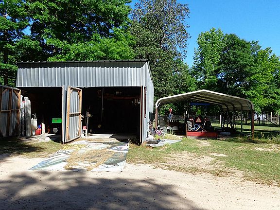 2 car carport beside shop.