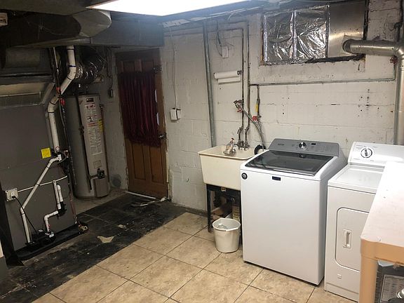 Basement Laundry/Storage Room with Exterior Access