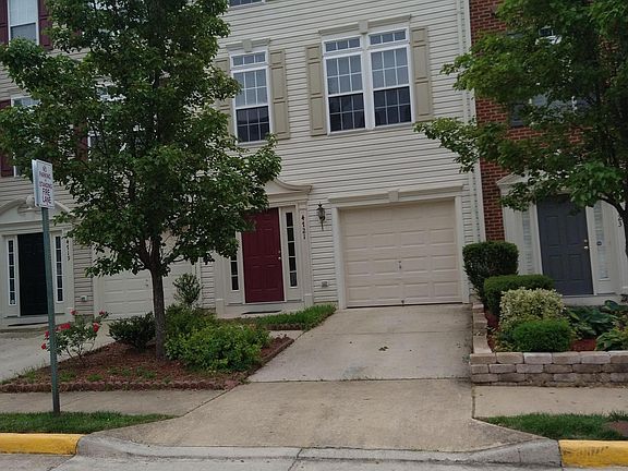 Three level townhouse with two sunrooms, 3 bedrooms, 2.5 bathrooms, and 1-car garage.