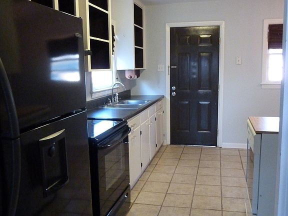 galley kitchen with refrigerator and range