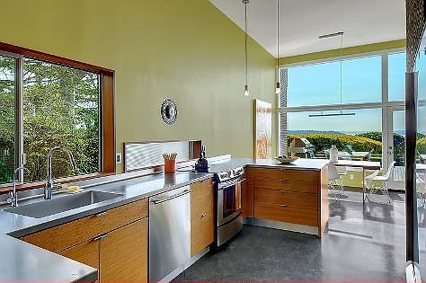 Delight in the open concept, circular floor plan in the kitchen, living and dining rooms with polished concrete floors.