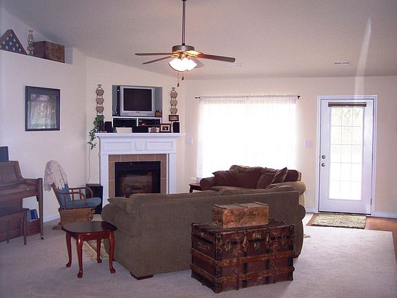 Family room with corner FP, plant ledges and lots of light.