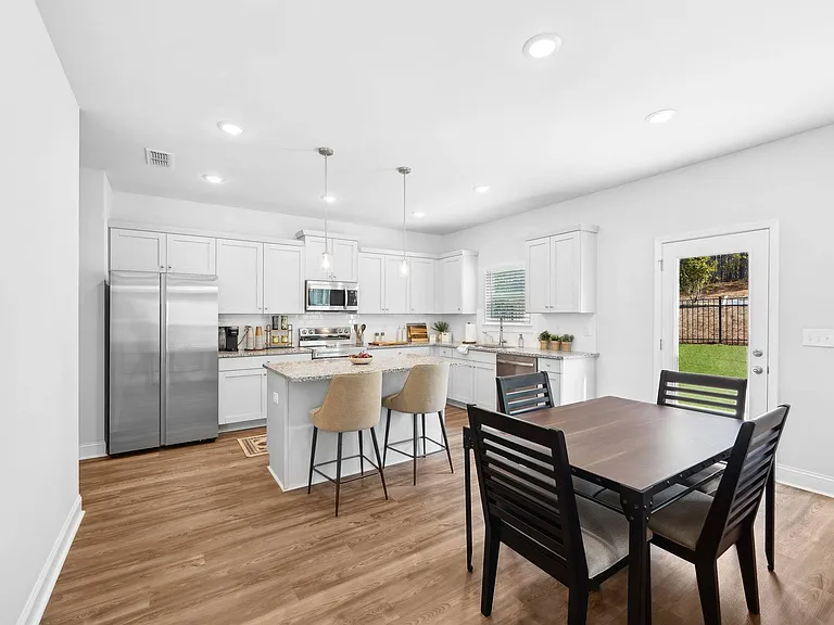 Spacious kitchen with an island, ample storage, and stainless steel appliances.