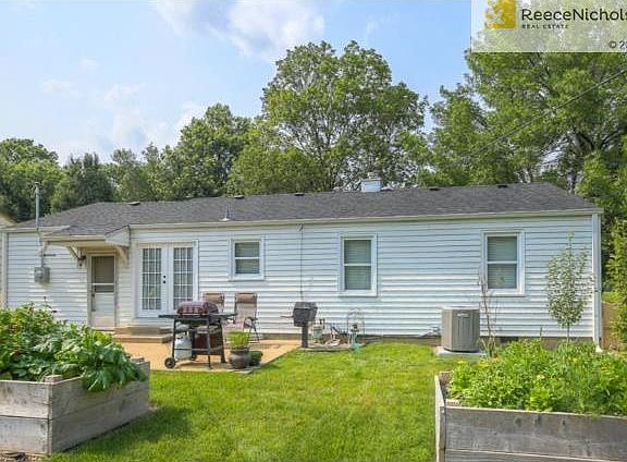 lARGE BACKYARD WITH VEGETABLE AND FLOWER GARDENS.