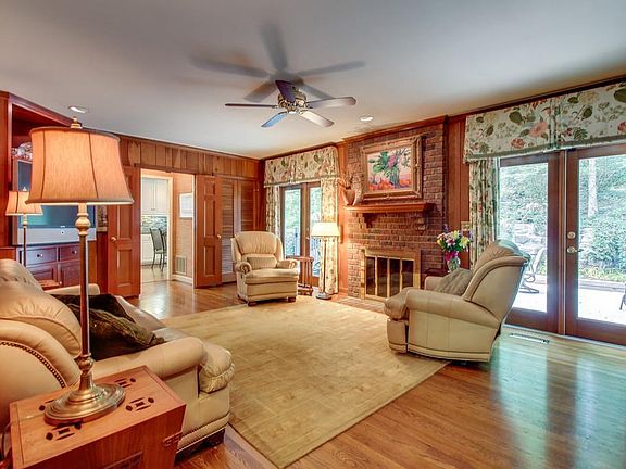 Cozy den with wood burning fireplace. Paneling has been removed and replaced with drywall.
